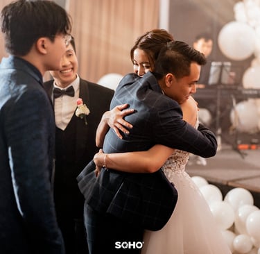 a bride and groom are hugging in a wedding ceremony