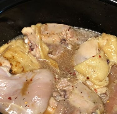 Carolina pulled chicken in slow cooker with spices and sauce