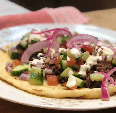 chuck roast gyro with garlic sauce and pickled onions
