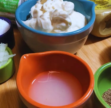 Prepared coleslaw ingredients in individual bowls, ready for mixing