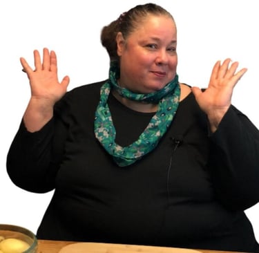 everyday dana with her hands up smiling at a table to show her weight loss journey in moderation