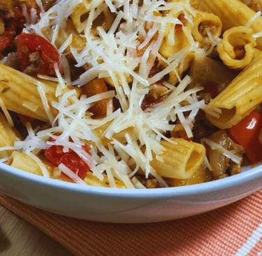 pasta and italian sausage in white bowl