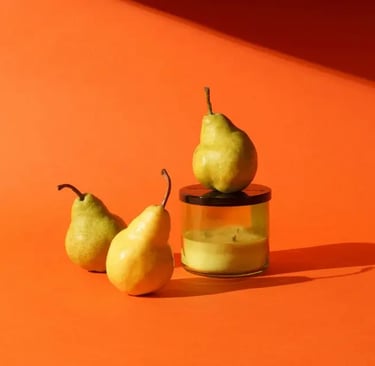 pears and candle with an fall colored orange background