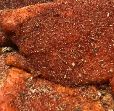blackened seasoning rubbed on steelhead trout fillets.