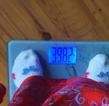 feet on marble looking weight loss scale showing weight