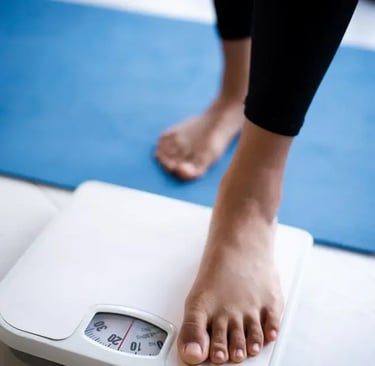 bathroom scale with feet stepping on . 
