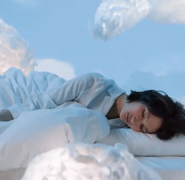 A peaceful image of a woman sleeping, surrounded by soft, fluffy clouds, symbolizing rest and tranquility.