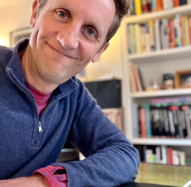 Marcus at desk with books in background