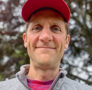 Headshot of Marcus wearing a red hat