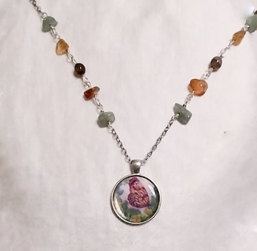 a necklace with a butterfly and flower on it