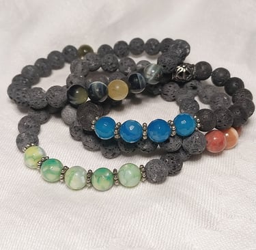 Stack of stretch bracelets blue brown black green