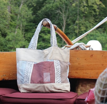 our tote bag from recycled fabric on an old wooden sailboat