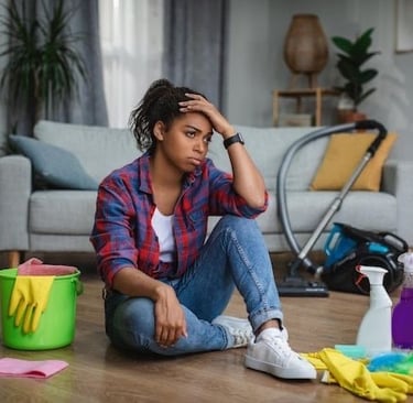 Woman frustrated sitting on the LVP flooring not knowing how to clean it