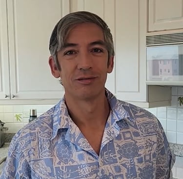 a person standing in a kitchen smiling