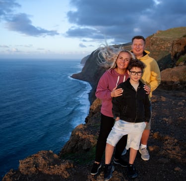Family posing at coastal cliff during golden hour Madeira
