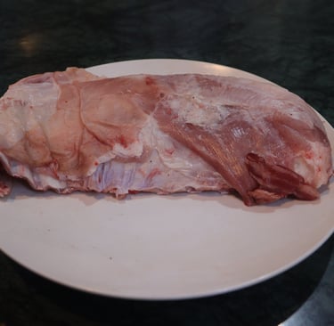 a piece of seena on a plate with a piece of meat on it