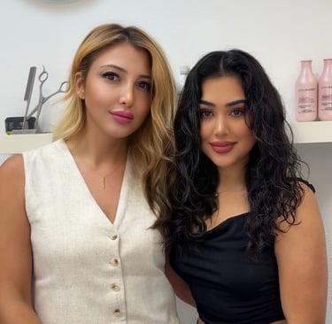 two women standing next to each other in a room