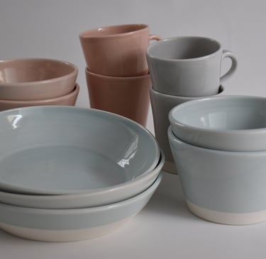Breakfast and Small bowls in Duck Egg Blue and Pale Pink. Mugs in Pale Pink and Pale Grey