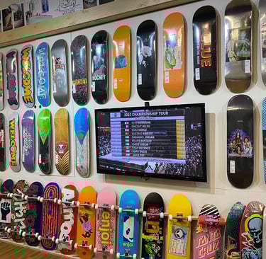 a wall of skateboards and skateboards on display