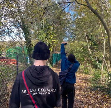 two friends are walking down a path