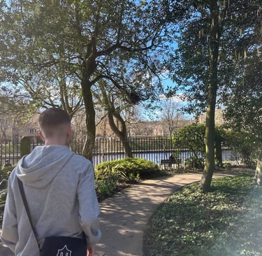 a man walking down a path with a dog