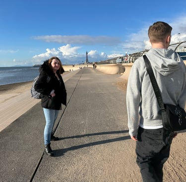 a man and woman walking down a sidewalk