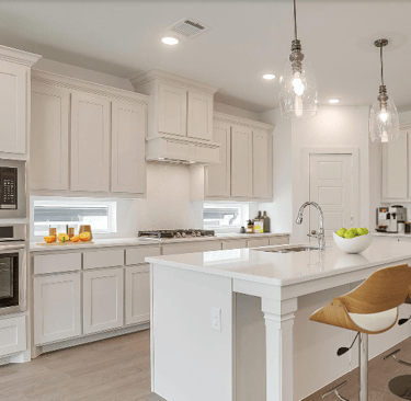 a kitchen with a large island and a bar stool