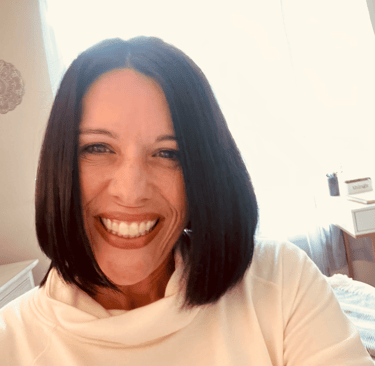 a woman with a white shirt and a bright smile