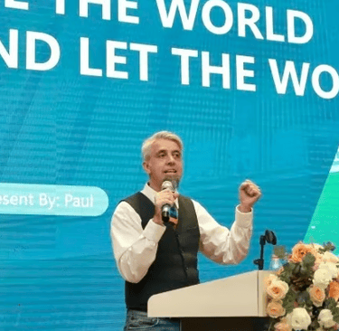a man standing at a podium with a microphone