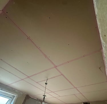 Plaster boarding finished and all edges taped with scrim tape ready to skim with plaster. 
