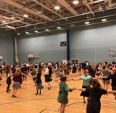 Dancers in a gymnasium, dancing circles