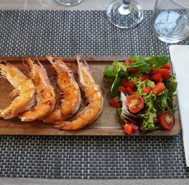 a table with food with a wood plate and salat