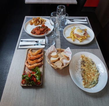 a fuul table with food in the restaurant of Yannis&Daddy