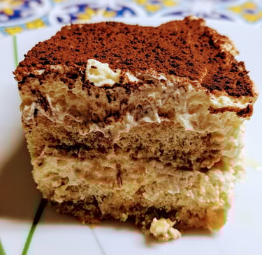 A rich, delicious slice of Tiramisu with Chocolate covered top