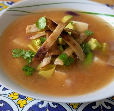 A fragrant bowl of Mexican Lime soup - Sopa De Lima with an Indian twist of Paneer for Protein, garnished with fried Tortilla