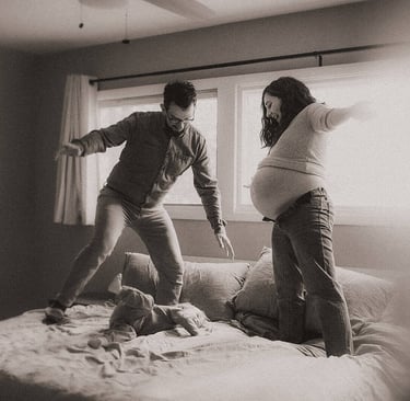 black and white photo of Duluth family playing on bed during in-home maternity session