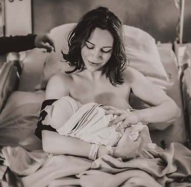 Mama holding her baby in the hospital bed right after birth