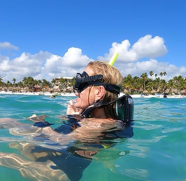 a woman in a diving suit is shown in the water