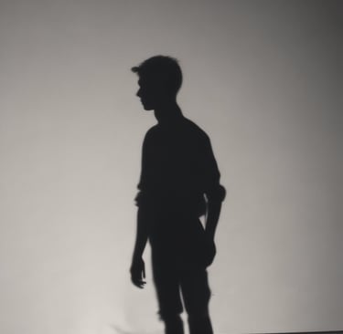 a man standing in front of a wall with a skateboard