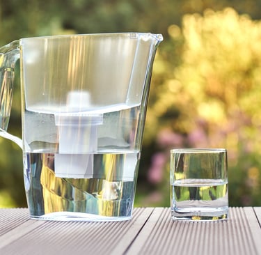 Eco-friendly water filter pitcher with a clean glass of water, sustainable alternative to bottled wa