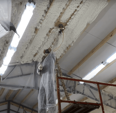 worker using spray foam gun