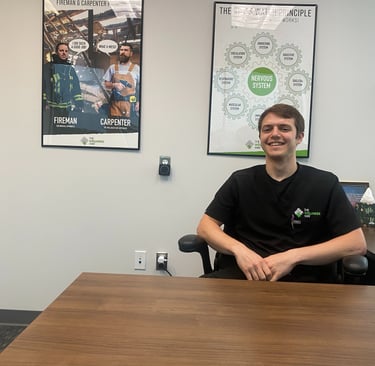 Dr. Sean smiling in his office with his patient 