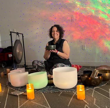 Kelly surrounded by her singing bowls 