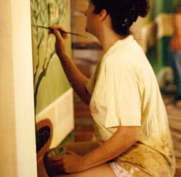 Christine painting a mural