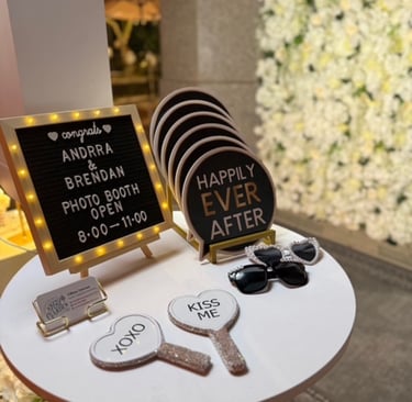 Wedding photo booth props with marquee letter board, heart-shaped signs, and party sunglasses.