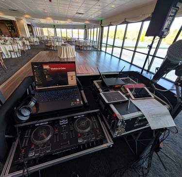 wedding DJ setup with DJ controller, laptop, microphone, ipads, and behringer x32