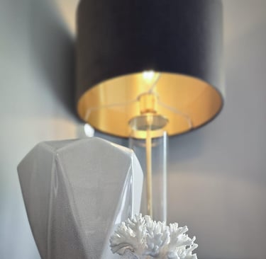 Black lamp with a gold interior and glass stem, illuminated, with decorative ornaments