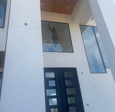 a man standing in front of a building with a window windows cleaning on post construction job