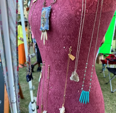 Jewlery made by a vendor pinned on a sewing form