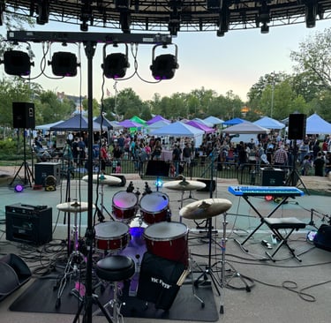 Cary Night Market Vendors and customers behind band set-up on stage